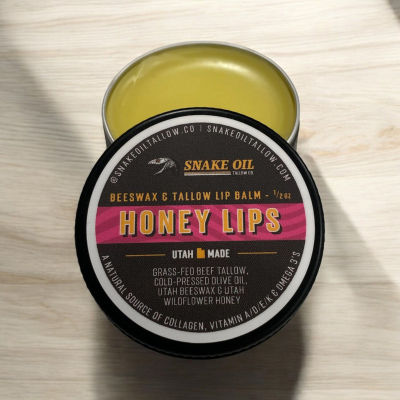 Snake Oil Tallow Co. Honey Lips beeswax and tallow lip balm in a small metal tin.