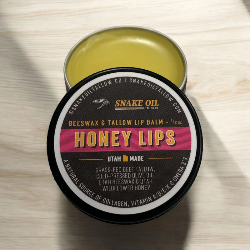 Snake Oil Tallow Co. Honey Lips beeswax and tallow lip balm in a small metal tin.